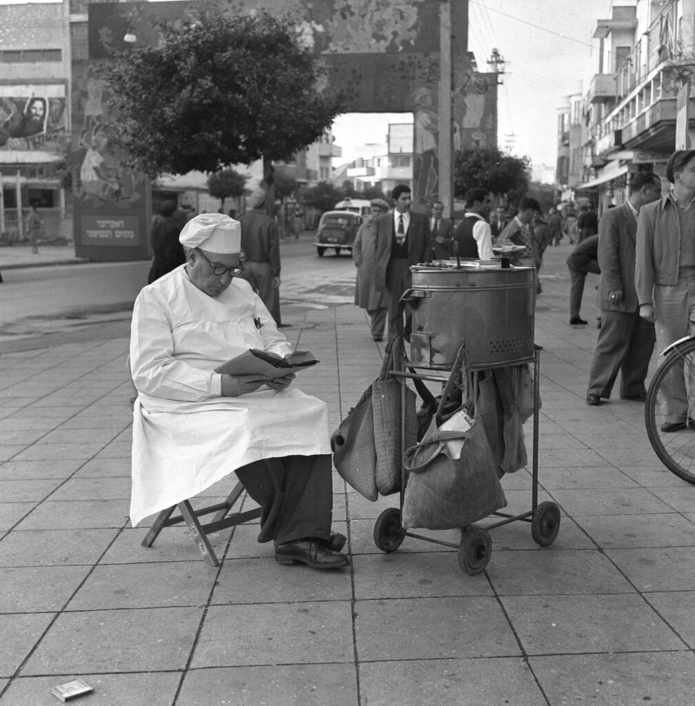 מוכר הנקניקיות פריץ גרסטנר, קורא בכתבי היינה, בכיכר מוגרבי - סלומון מקסים